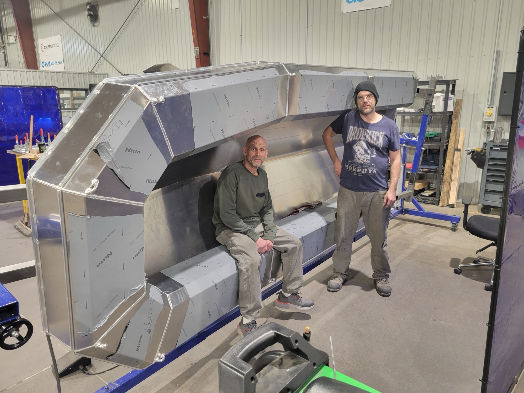 Pure Life Machinery team beside a large stainless build